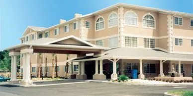 A large building with a blue door and a parking lot.